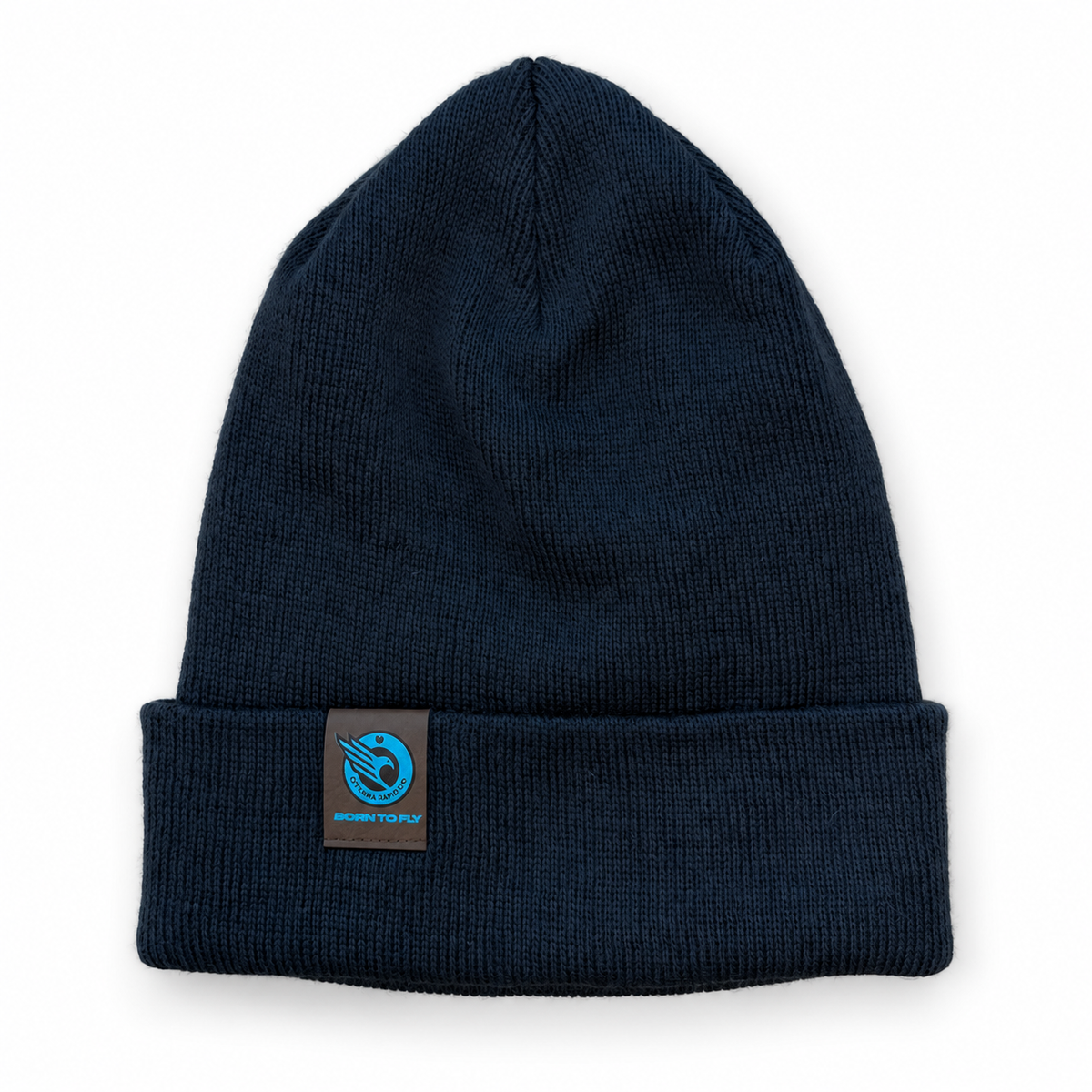 A dark navy ribbed knit toque with a folded cuff, featuring a small brown leather square patch on the front with the RAPID FC logo and the text 'BORN TO FLY'.